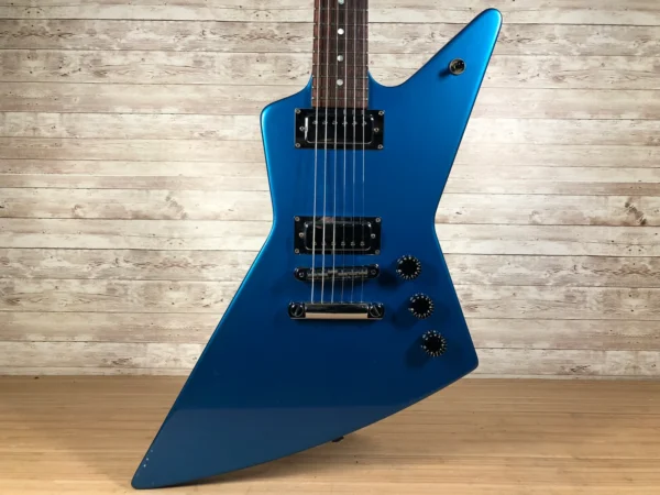 Wow! Really cool and rare 2003-04 Gibson X-Plorer Studio. Impressively ergonomic mini-sized explorer basswood body, mahogany neck with a 22-fret rosewood fingerboard, and chrome hardware. Features two high-output ceramic mini-humbuckers. Originally available in a variety of metallic finishes including Studio Blue, Studio Copper, Studio Green, Studio Red and Studio Yellow. A few minor dings here and there and some lacquer checking but nothing major. Fresh Cask setup, fantastic player with fresh frets. Includes original fitted Gibson hardshell case!