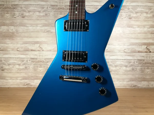 Wow! Really cool and rare 2003-04 Gibson X-Plorer Studio. Impressively ergonomic mini-sized explorer basswood body, mahogany neck with a 22-fret rosewood fingerboard, and chrome hardware. Features two high-output ceramic mini-humbuckers. Originally available in a variety of metallic finishes including Studio Blue, Studio Copper, Studio Green, Studio Red and Studio Yellow. A few minor dings here and there and some lacquer checking but nothing major. Fresh Cask setup, fantastic player with fresh frets. Includes original fitted Gibson hardshell case!